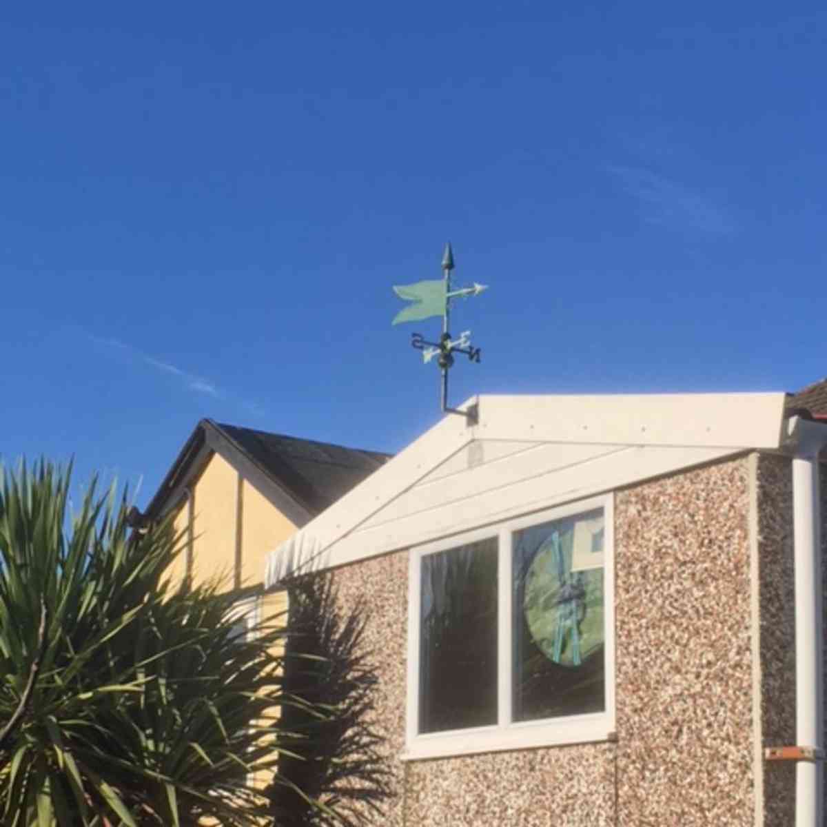 copper verdigris banner weathervane installed